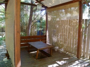 A patio shaded by bamboo