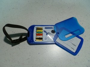 Luggage tag opens to a sewing kit