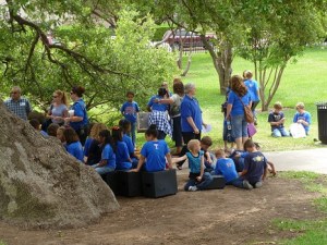 A group of students in matching blue t-shirts