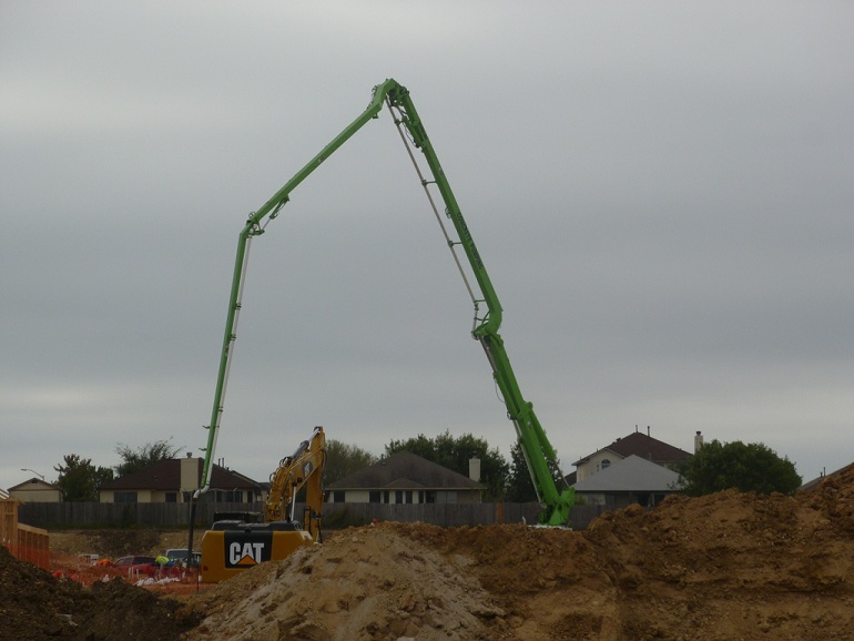 A big green crane at a construction site