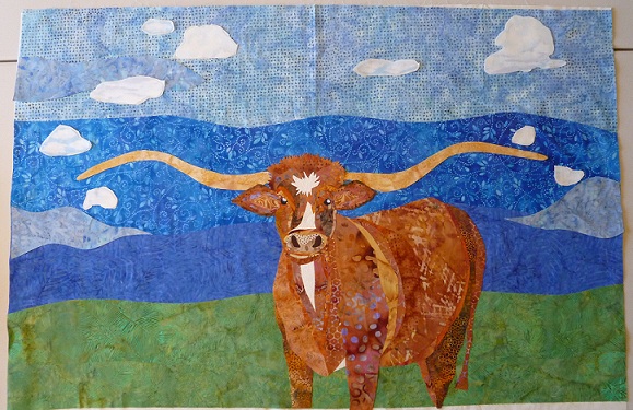 Longhorn applique on the sky and grass fabric background