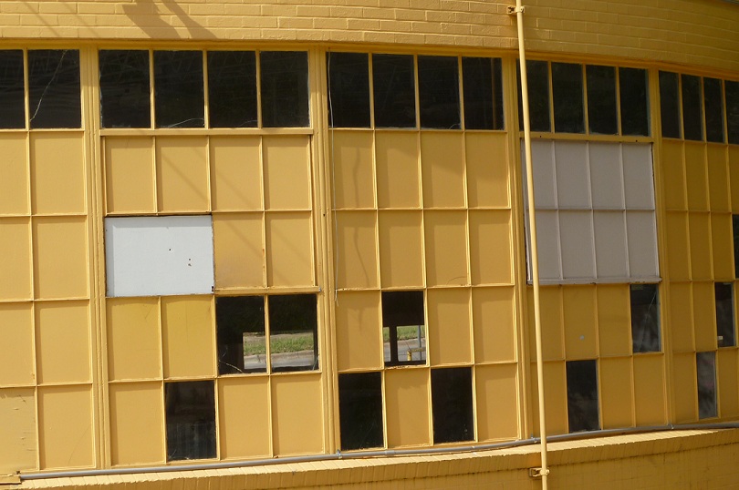A building with most of its windows painted yellow