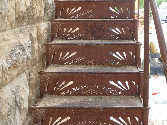 A metal staircase, on a building's outside wall