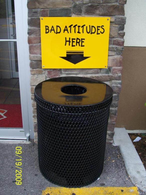 A sign saying leave bad attitudes in the trash can