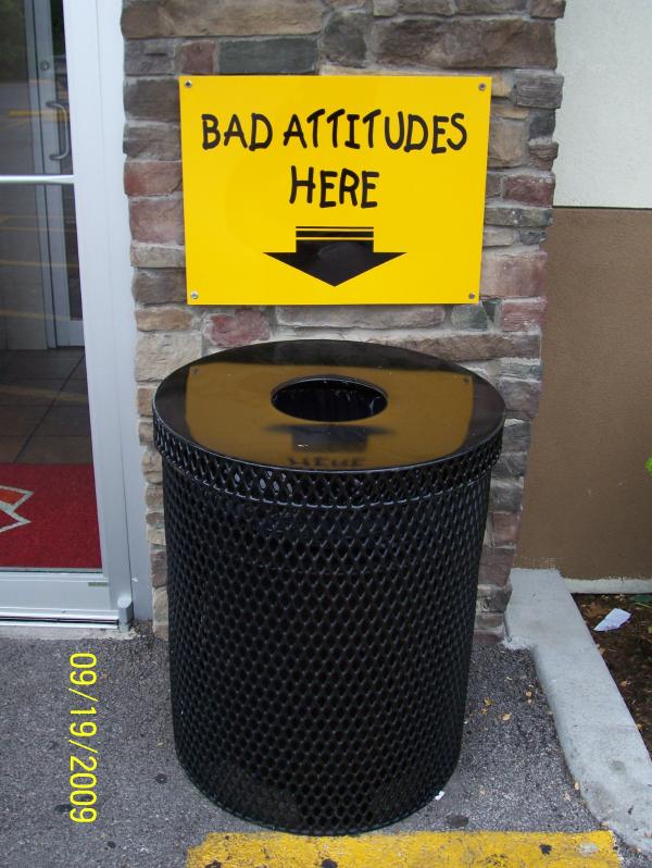 A sign saying leave bad attitudes in the trash can