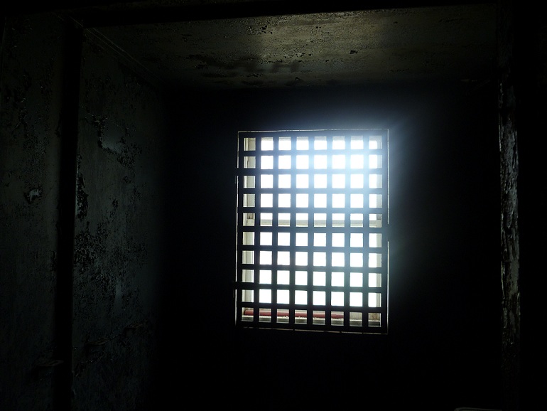 Looking out a jail cell window