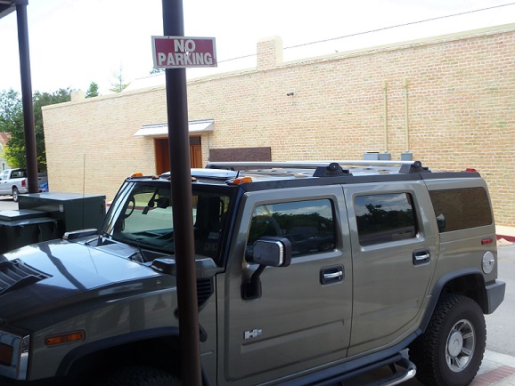 A vehicle parked under a No Parking sign