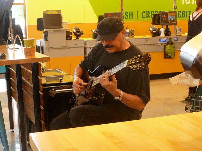 Buzz Guerra playing the acoustic guitar at Whole Foods Market