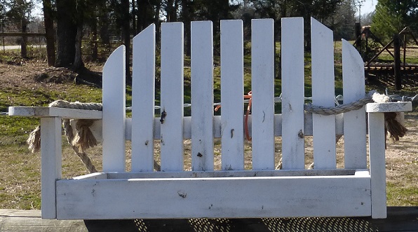 A tiny outdoor bench as a bird feeder
