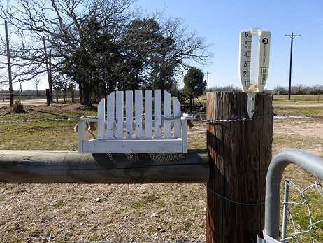 A bird feeder on a fence