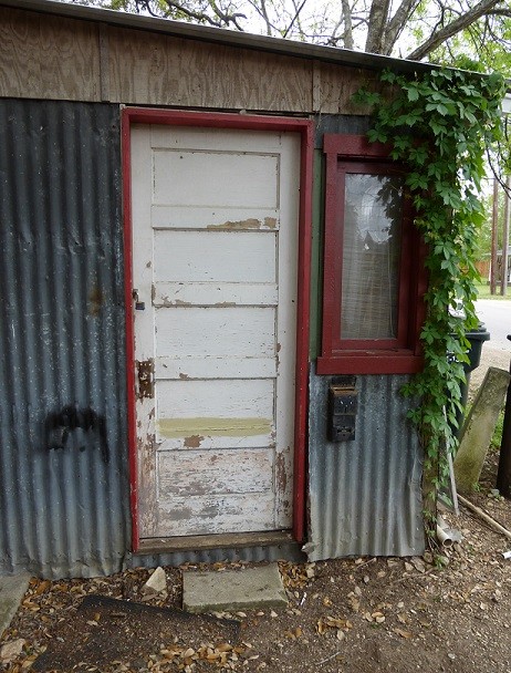 An old door leading into a metal building