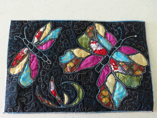 A Mola book cover with a butterfly design