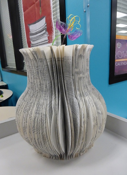 A book with folded pages now a flower vase