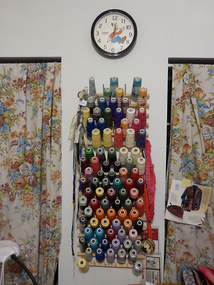 A serger thread rack hanging on the wall