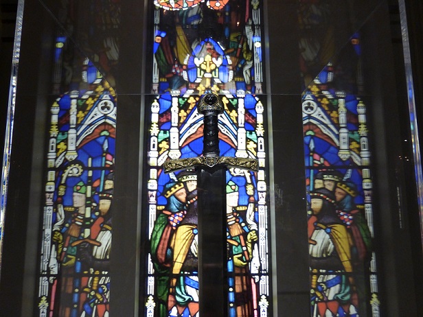 Stained glass window behind a King Arthur-type sword