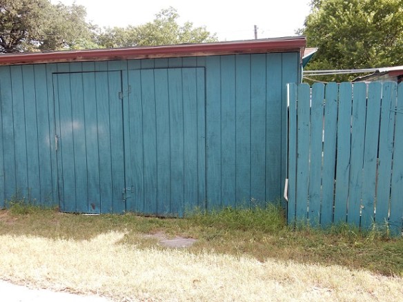 A blue wooden shed