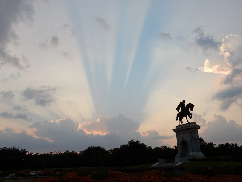 Sunset in Houston, Texas, with the statue of Sam Houston at the right side of the photo