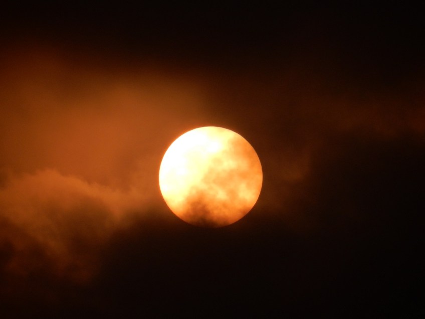 The sun clearing the morning clouds