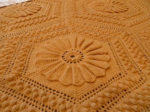 Close up of a crocheted bedspread