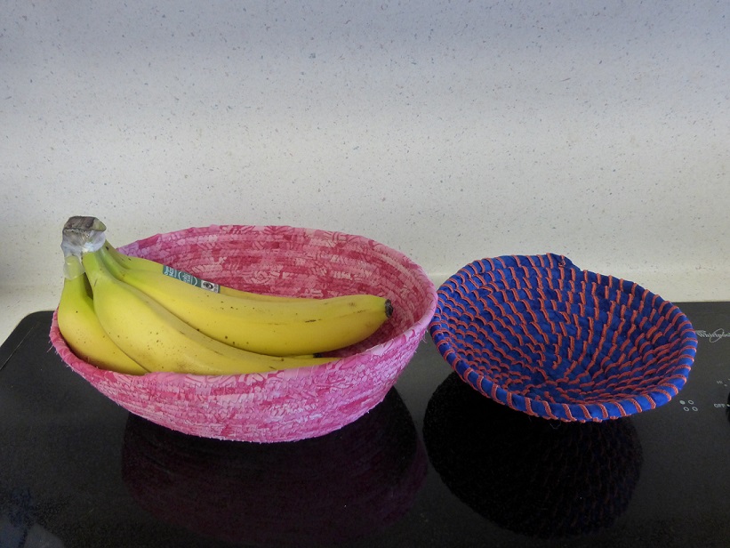 Pink bowl with bananas in it to show size