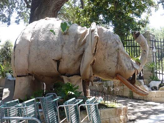 An organic elephant at a garden center with plants growing on it