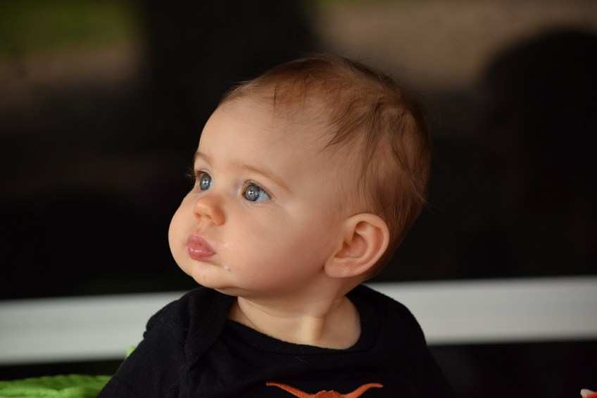 Madison, a baby, looking off in the distance