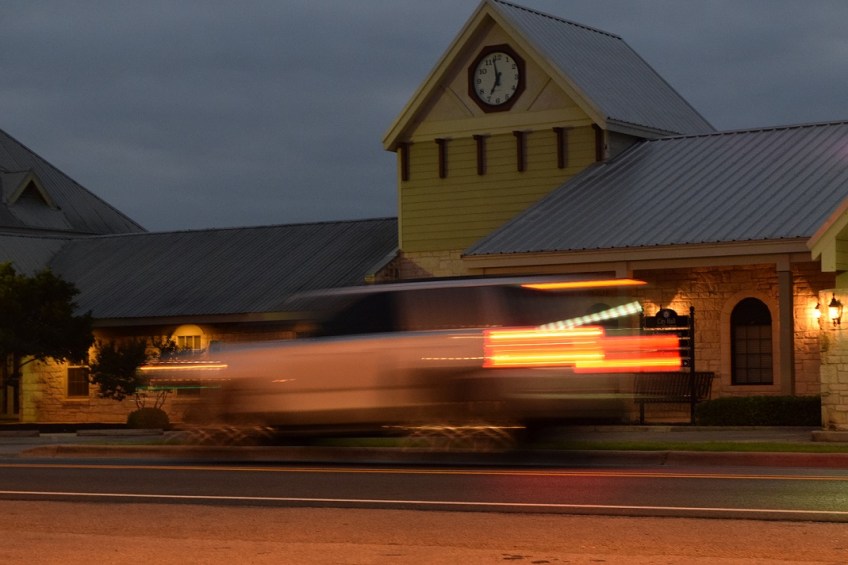 A photo of the Buda City Hall clock in focus and a vehicle driving by in a blur, which was the desired effect.