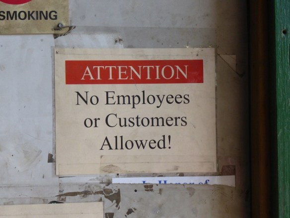 A sign at a recycling business that reads: Attention. No employees or customers allowed.