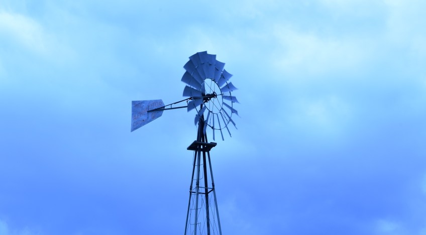 A windmill with purple, blue and lavender skies