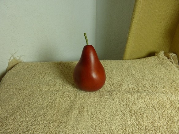 A plastic red pear as my sketching subject in what I call my home studio: the corner of my dining room