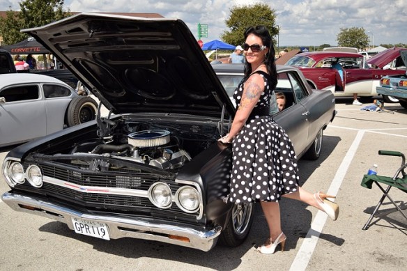 A black car and the owner in a black and white polka dot dress.  Her young daughter stuck her head out the window of the car just as I took the photo.