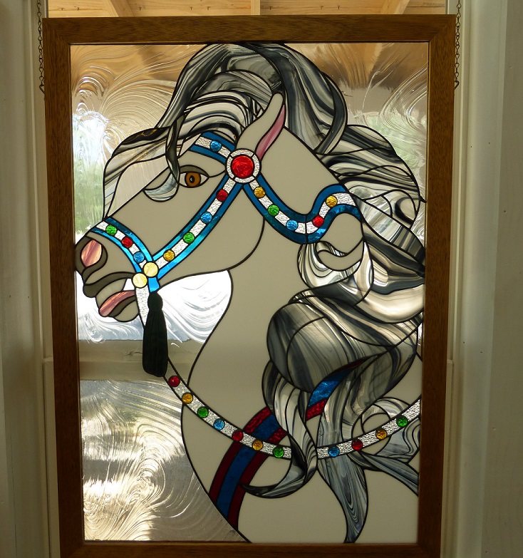A stained glass window of a carousel horse