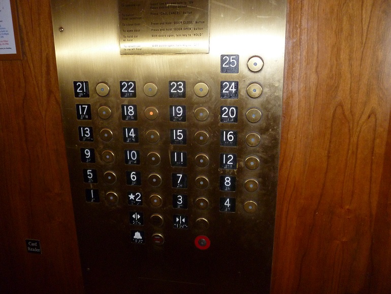 Elevator panel in a tall building with all the floor numbers displayed