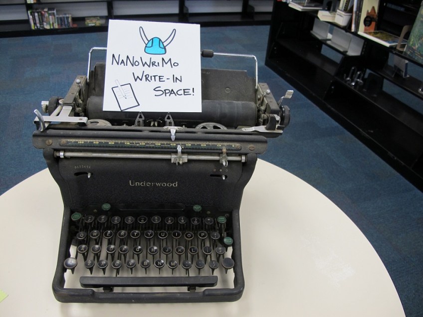 The sign on the typewriter that says "NaNoWriMo Write-In Space"