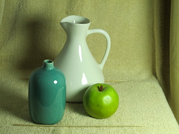 The still life objects: the vase, the pitcher, the apple