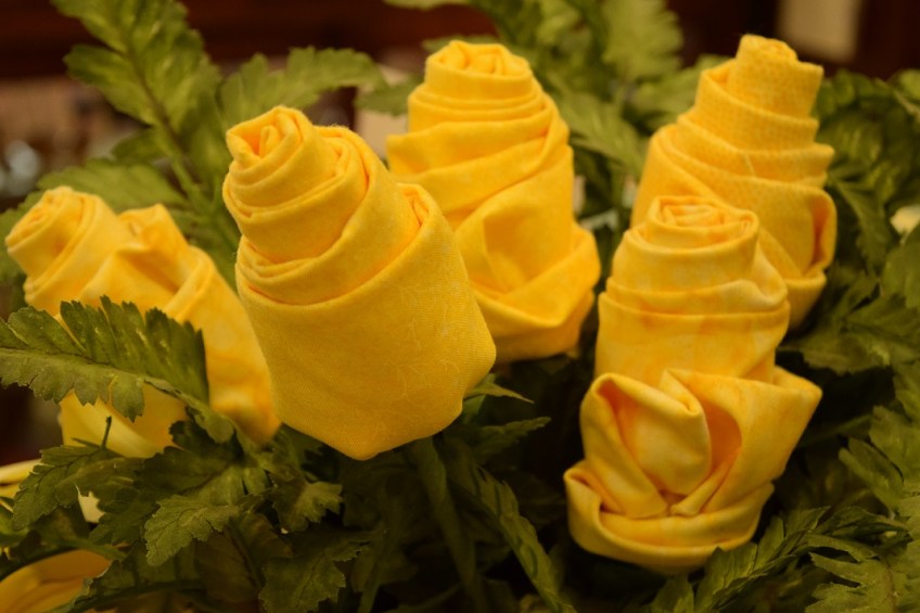 A bouquet of roses made from yellow quilting fabric