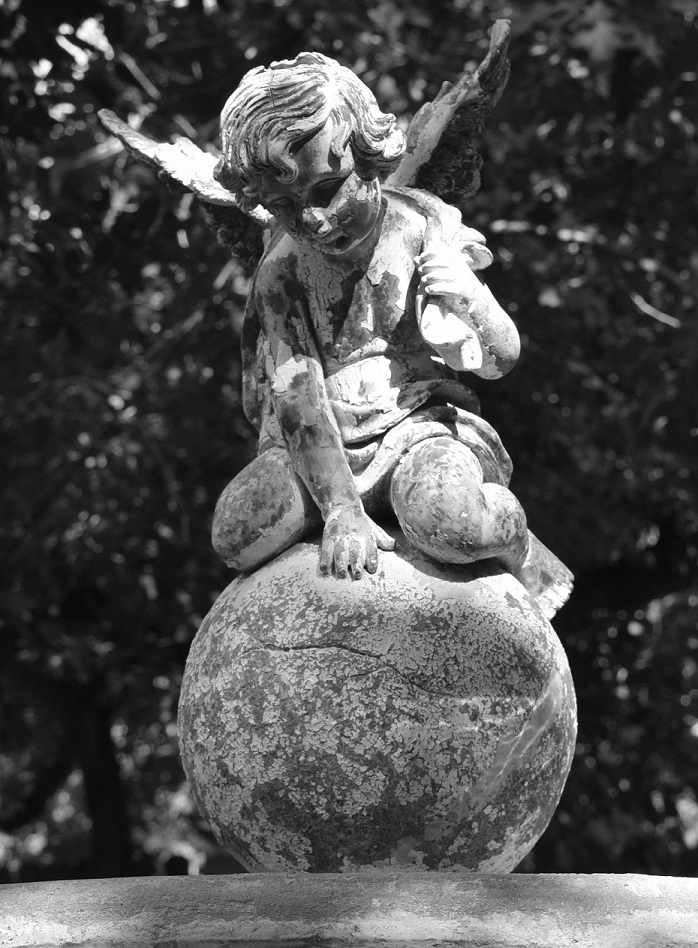 garden angel statue in a black and white photo