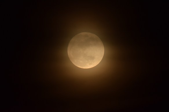 Moonrise through some hazy clouds
