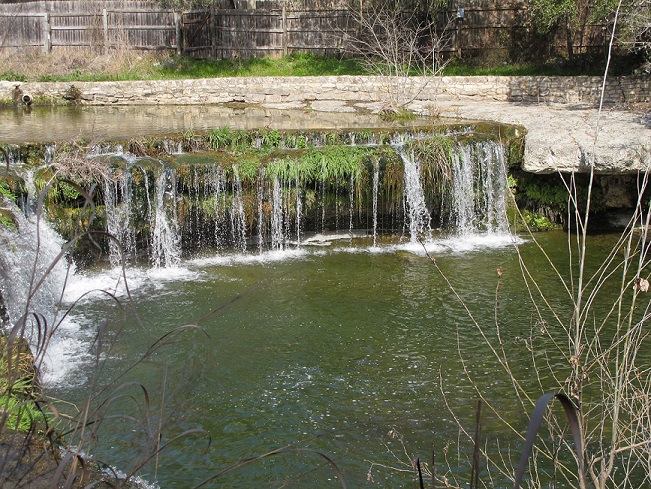 Small creek waterfall flowing with water from recent rains
