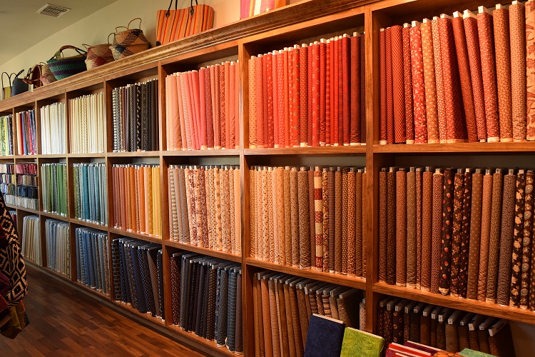 Wall of fabric at The Quilted Skein, La Grange, Texas