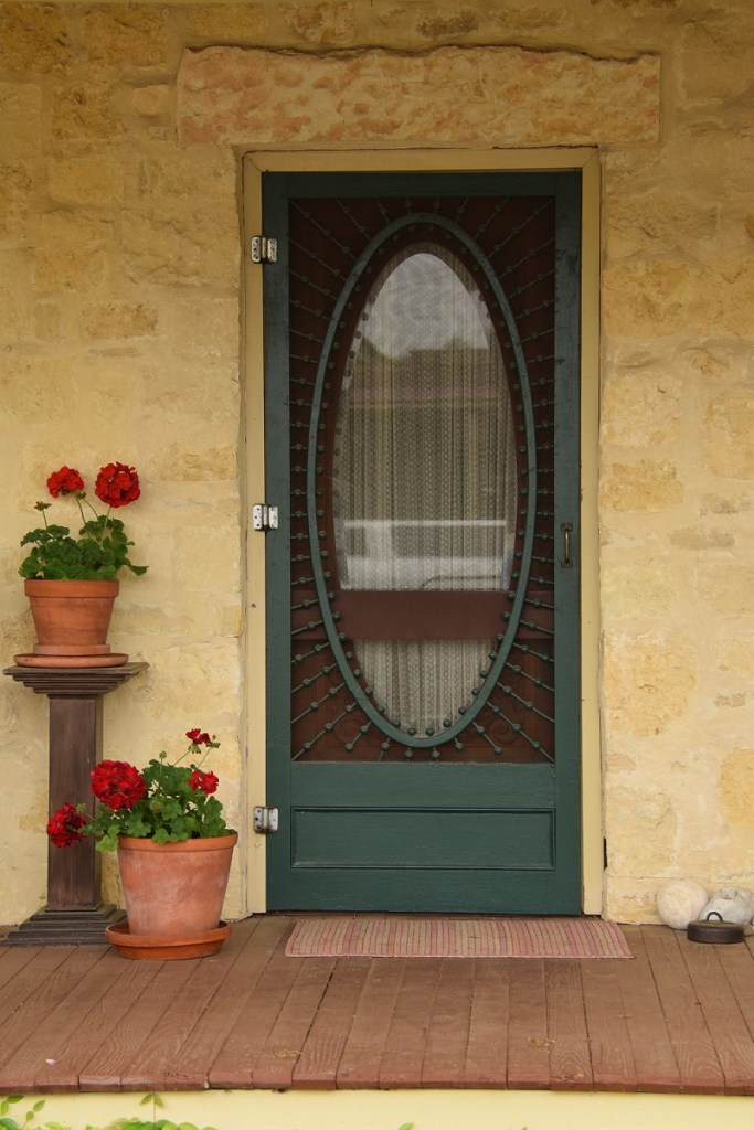 House door with geraniums
