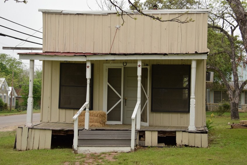 House with a hay bale on the porch
