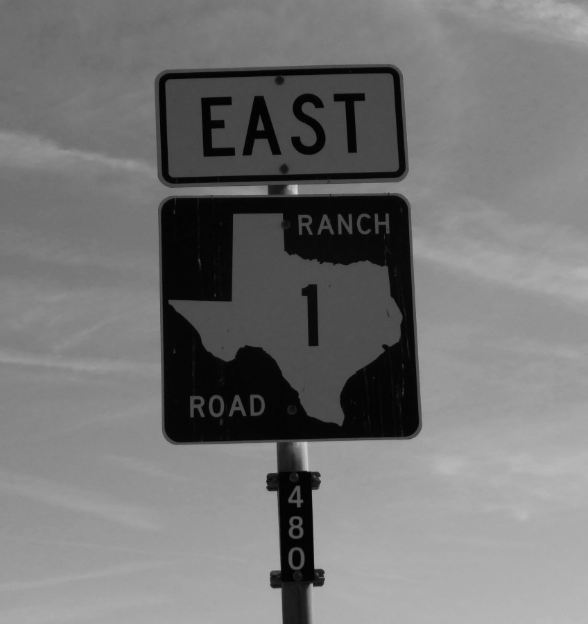 Texas highway sign indicating "East, Ranch Road 1"