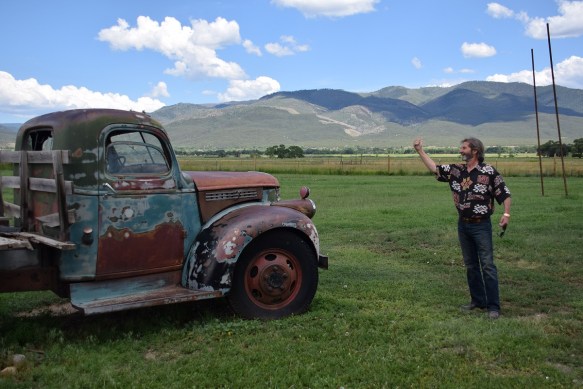Old GMC pickup with a man in front of it, as if he is hitchhiking