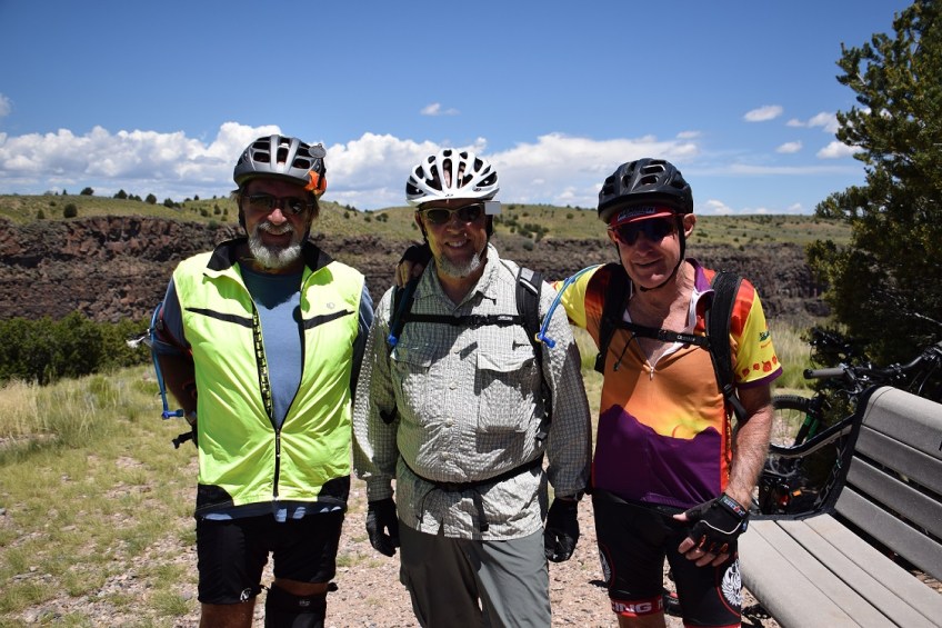 Three cyclists on the trail