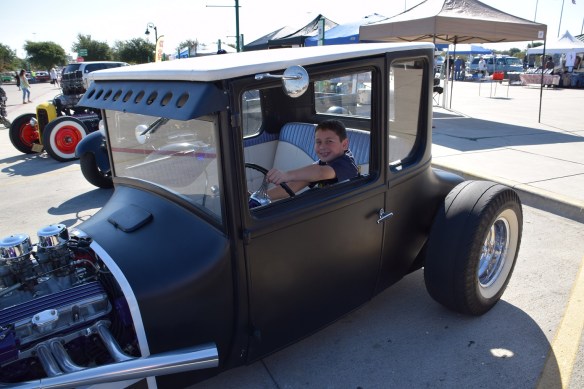 A young boy sitting in an old, old car at the Buda Gearhead's car show October 2015