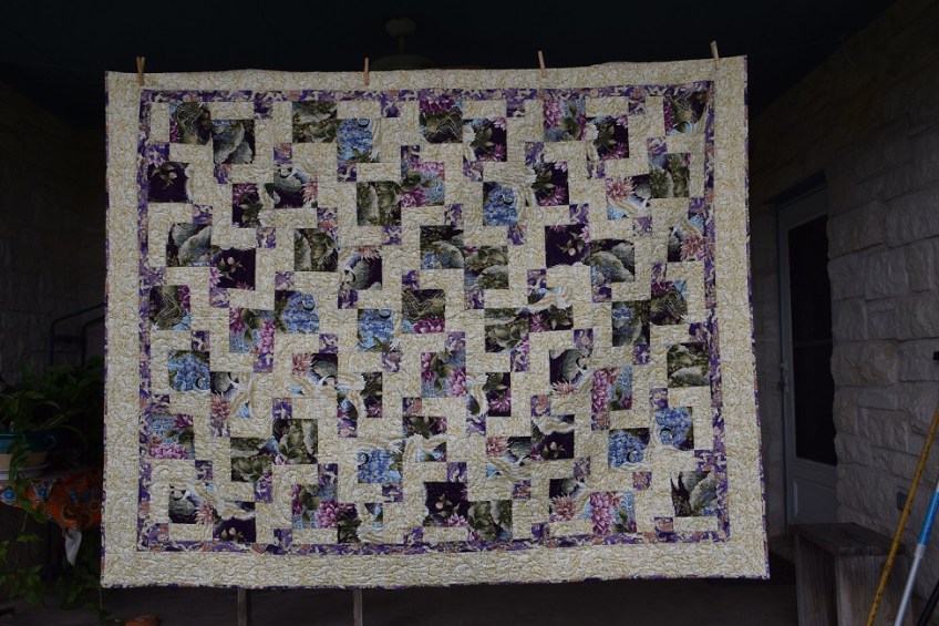 Three fabrics in a Disappearing Nine Patch arrangement